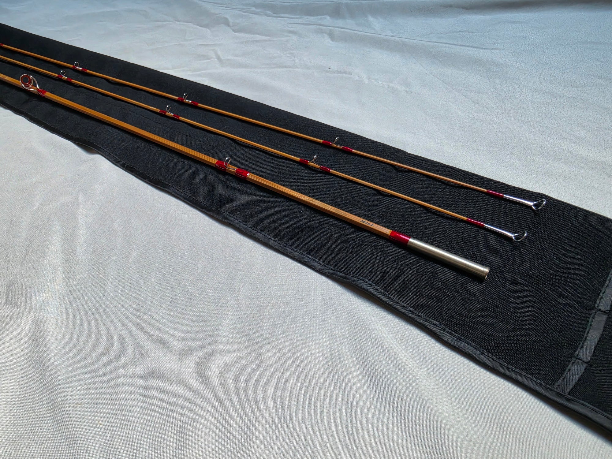 Finished Dickerson 7613 split-cane fly rod, 7'6" 5wt two-tip, laid out with cloth rod bag