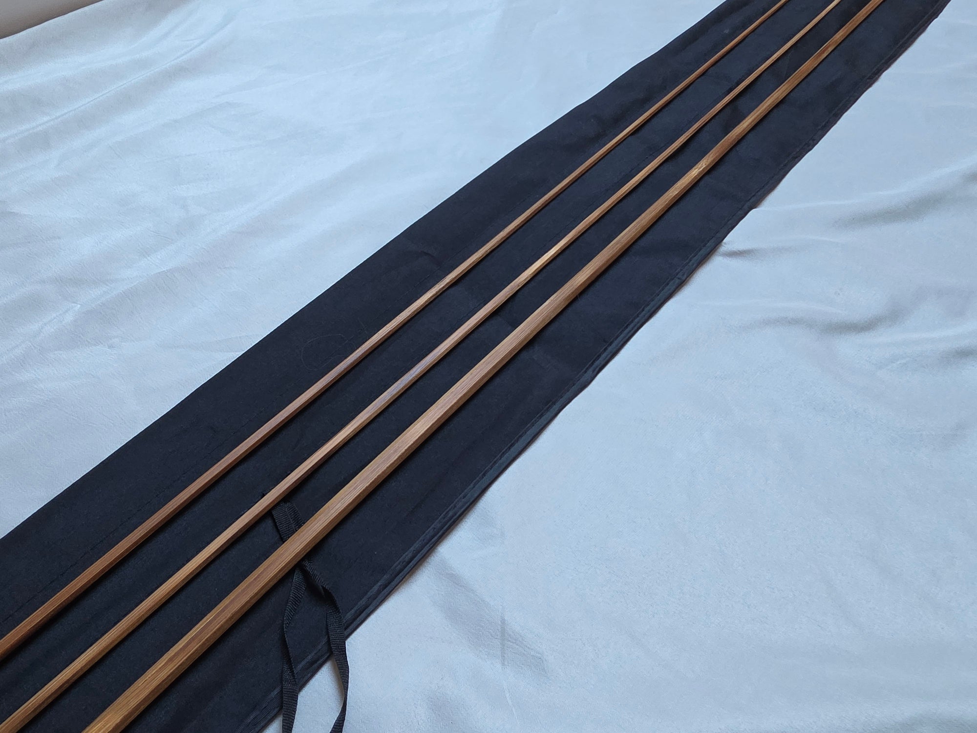 Flame-tempered Powell taper bamboo rod blank sections with cloth bag