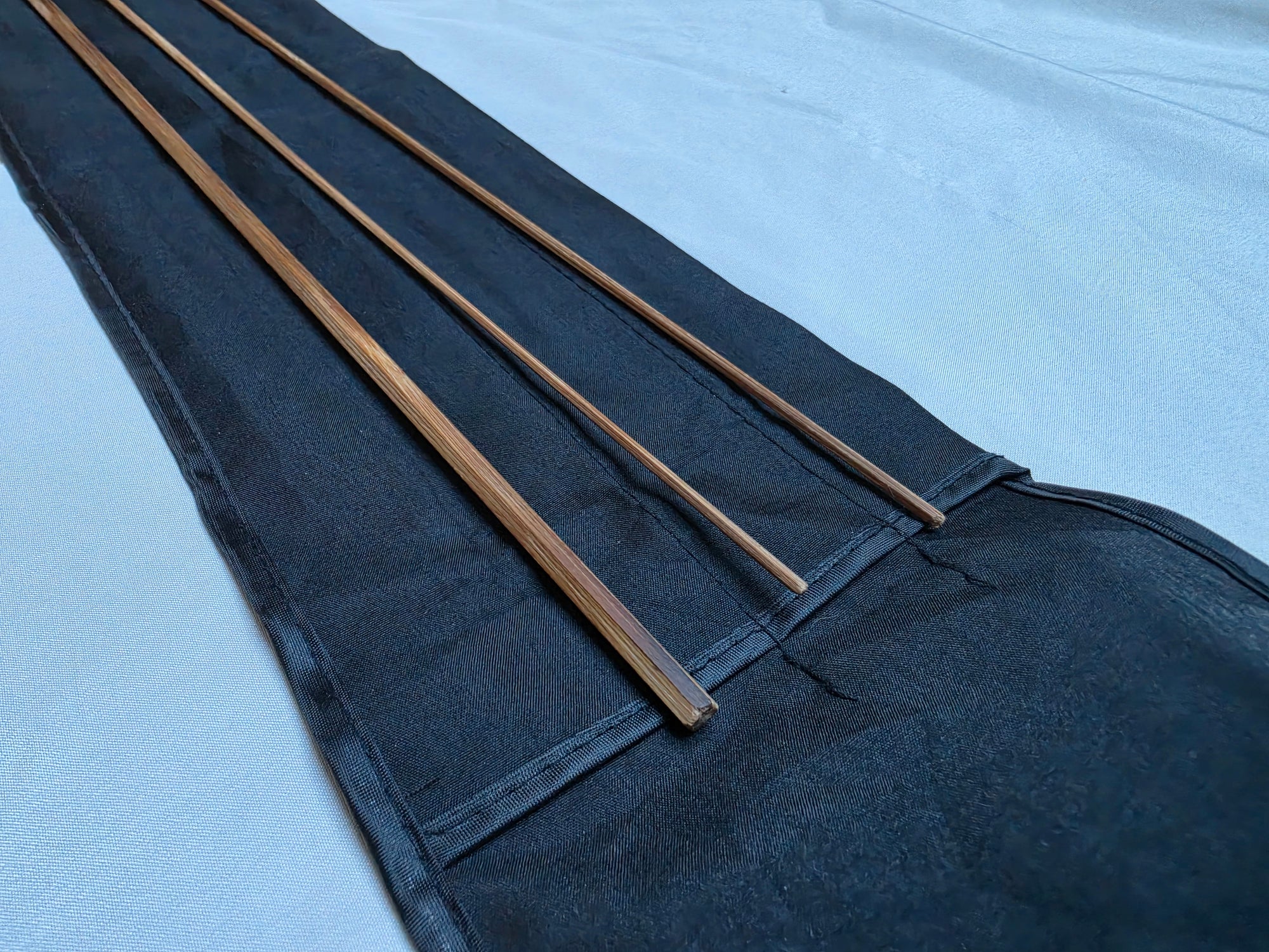Close-up of flame-tempered bare-cane Powell taper bamboo rod blank, no ferrules installed