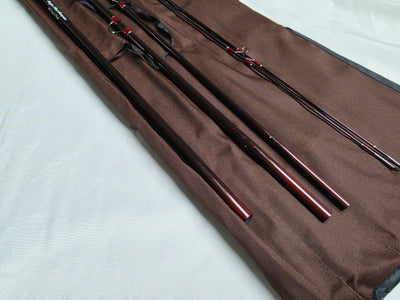 Four-piece IM6 graphite Spey rod sections in brown cloth rod bag
